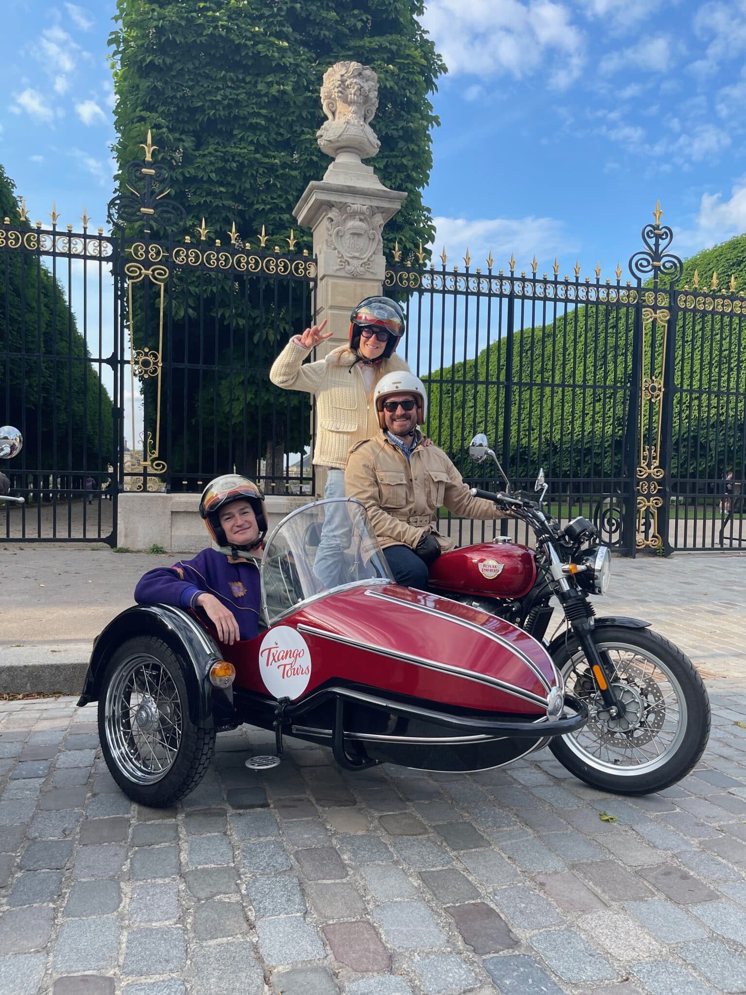 Friends on a side car tour past the Luxembourg Gardens